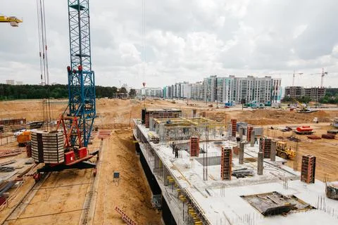 Construction site background. Hoisting cranes and new multi-storey buildings Stock Photos