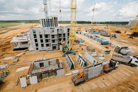 Construction site background. Hoisting cranes and new multi-storey buildings Stock Photos
