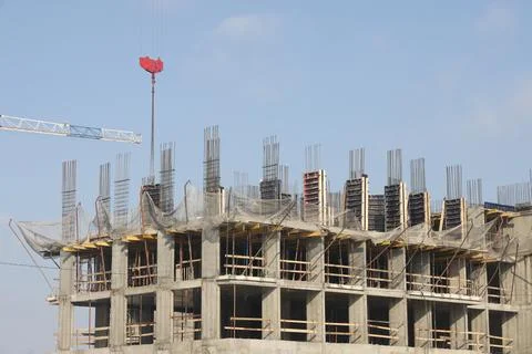 Construction site background. Hoisting cranes and new multi-storey building.. Stock Photos