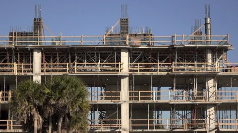 Construction site behind palm tree in tropical location 4k Vidéo 126730411