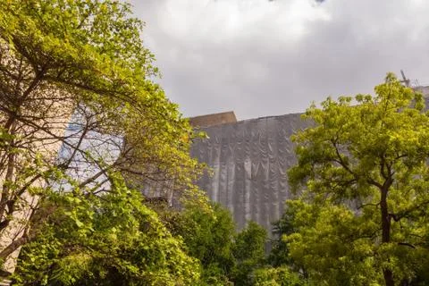 A construction site behind trees Stock-Fotos