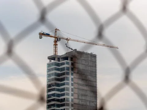 Construction site behind the wire net fence. Stock Photos