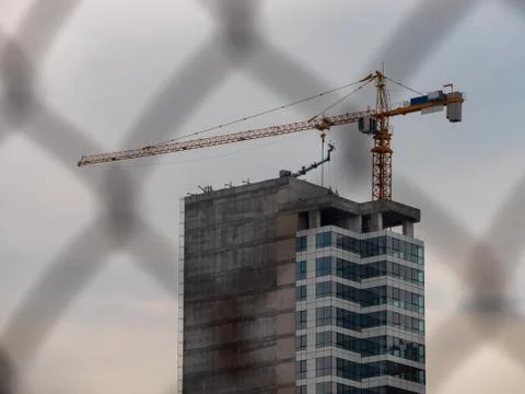 Construction site behind the wire net fence. Stock Photos