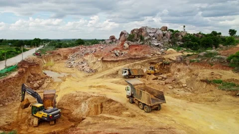 Construction site beside road with volvo crawler Excavators and trucks in Stock Footage 300840657