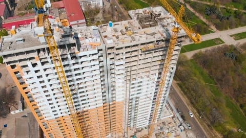 Construction site with a bird's eye in a megacity.Building in the city.Big crane Stock Footage 89403585