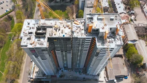 Construction site with a bird's eye in a megacity.Building in the city.Big crane Stock Footage 89409447