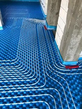 Construction Site with Blue Underfloor Heating System Installation Stock Photos