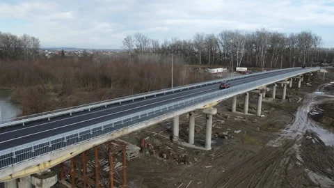 Construction site of a bridge across the road . Bird eye. big faucet. Aerial Stock Footage 230933752