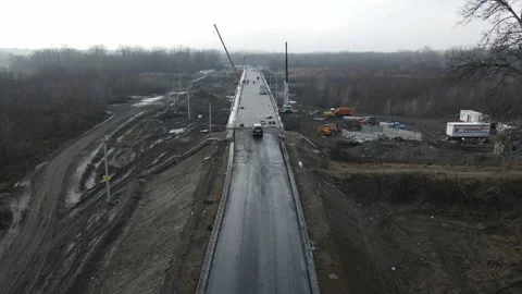 Construction site of a bridge across the road . Bird eye. big faucet. Aerial Stock Footage 231641008