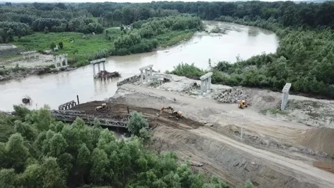 Construction site of a bridge across the road . Bird eye. big faucet. Aerial Stock Footage 232541141