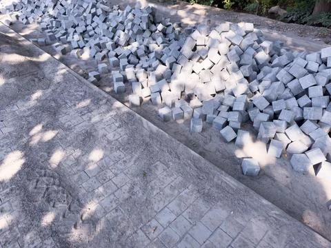 Construction site, broken footpath, road repair, concrete. A pile of gray bricks Stock Photos