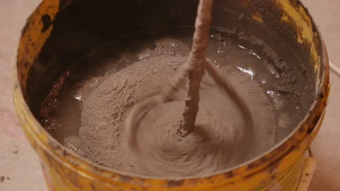 Construction Site. Builder Mix Solution in Bucket. Plaster. Glue. Cement. Putty Stock Footage 145044625