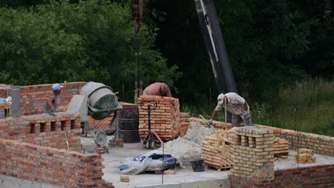 Construction site. Builder workers are building the wall of a house from bricks. Stock-Footage 314175880