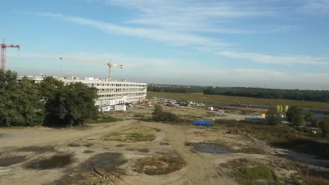 Construction Site with building and trucks driving and cranes Dron HD Stock Footage 136025924