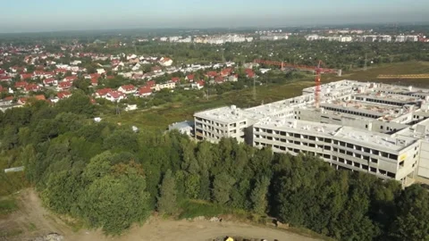 Construction Site with building and trucks driving and excavator Dron HD Stock Footage 136026534