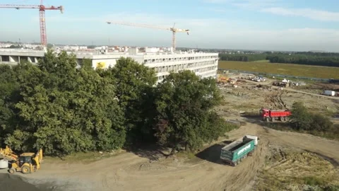 Construction Site with building and trucks driving Dron HD Stock Footage 136026650