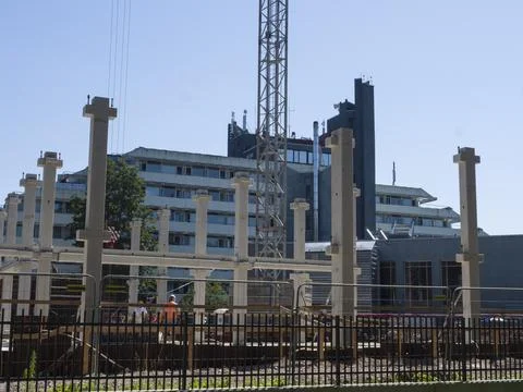 Construction site with building being built cranes in background. Workers and Stock Photos