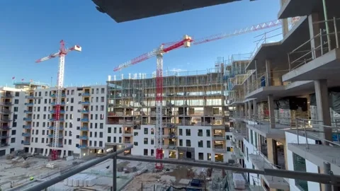 Construction site building cranes moving on a sunny day Stock-Footage 326092483