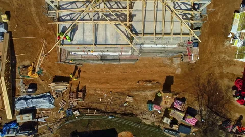 A construction site with building materials and excavation work in Vídeos de archivo 291779687