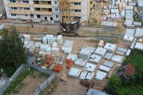 Construction site with building materials, part of crane at summer day Stock Photos