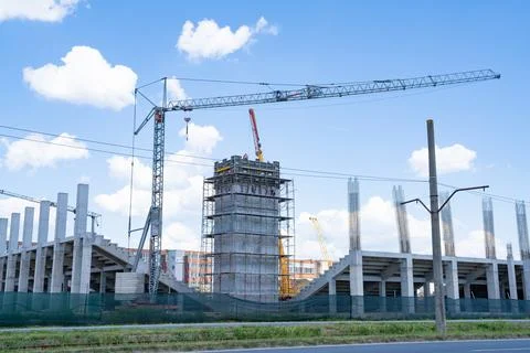 Construction site, building under construction in the city, cranes and clou.. Stock Photos