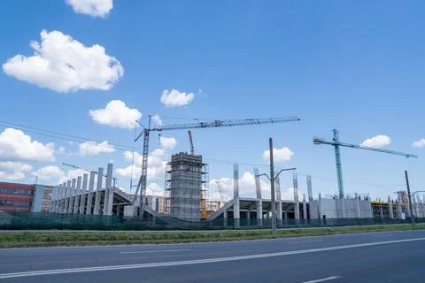 Construction site, building under construction in the city, cranes and clou.. Stock Photos