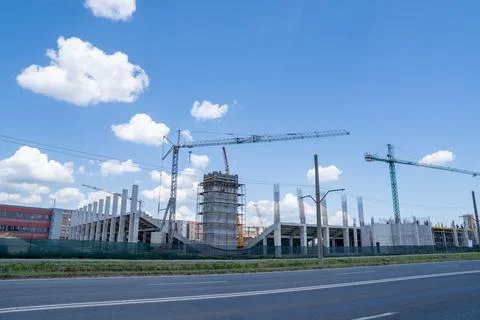 Construction site, building under construction in the city, cranes and clou.. Stock Photos