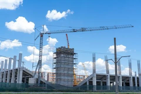Construction site, building under construction in the city, cranes and clou.. Stock Photos