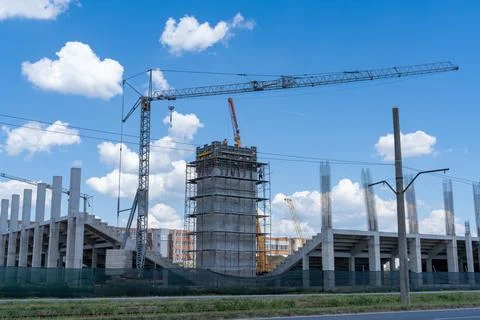 Construction site, building under construction in the city, cranes and clou.. Stock Photos