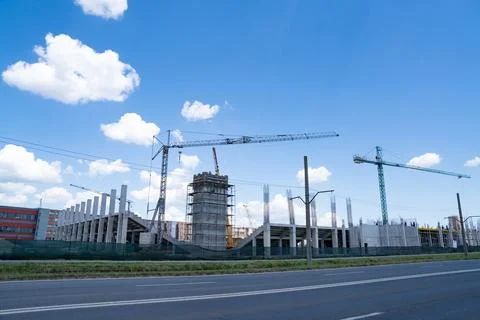 Construction site, building under construction in the city, cranes and clou.. Stock Photos