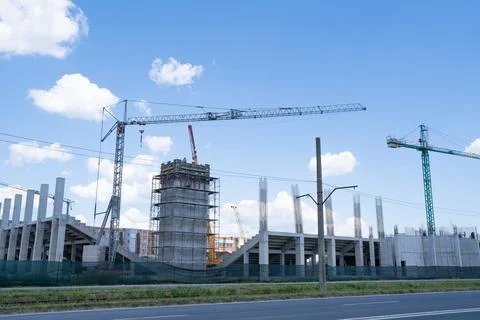 Construction site, building under construction in the city, cranes and clou.. Stock Photos