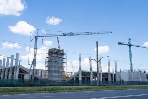 Construction site, building under construction in the city, cranes and clou.. Stock Photos