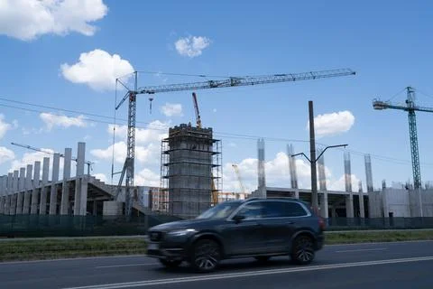 Construction site, building under construction in the city, cranes and clou.. Stock Photos