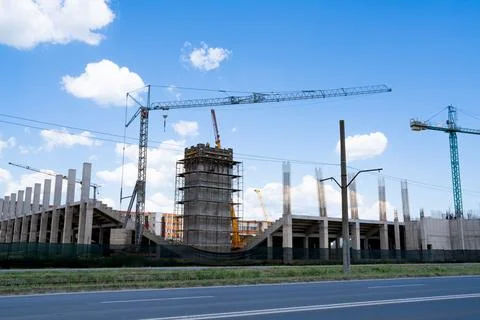 Construction site, building under construction in the city, cranes and clou.. Stock Photos