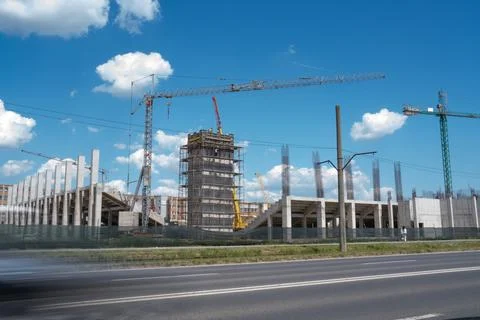 Construction site, building under construction in the city, cranes and clou.. Stock Photos
