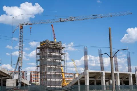 Construction site, building under construction in the city, cranes and clou.. Stock Photos
