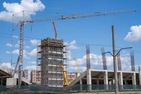 Construction site, building under construction in the city, cranes and clou.. Stock Photos