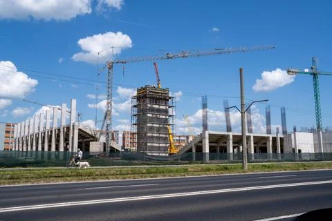 Construction site, building under construction in the city, cranes and clou.. Stock Photos