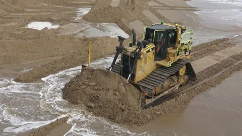 Construction Site Bulldozer Bulldozing Sand Up To A Pipeline On The Beach Stock Footage 150506549