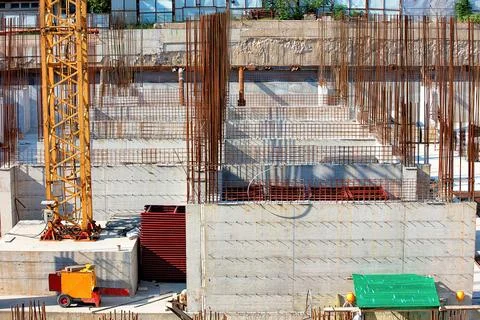 Construction site bustling with activity under a bright sun in an urban env.. Stock Photos