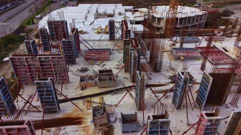 Construction site buzzes with activity as workers build a new structure Stock Footage 332096639