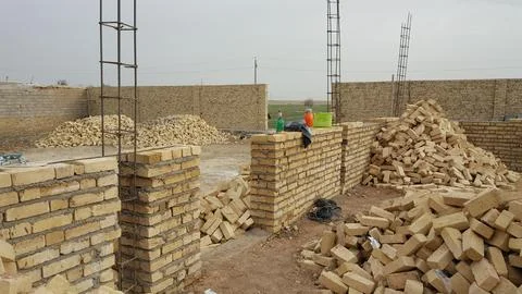 A construction site with clay bricks stacked neatly, stock photo. Stockfoto's