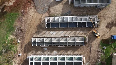 Construction site with concrete foundation structures, aerial drone view. A Stock Footage 335347473