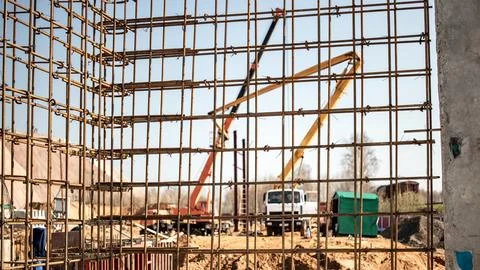Construction site with concrete framework and machinery in progress during .. 스톡 사진