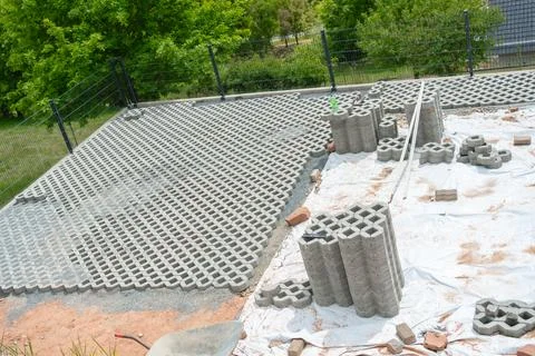 Construction Site with Concrete Grid Blocks Installation Foto stock
