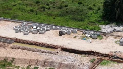 Construction Site with Concrete Pipes and Green Background Stock Footage 344810898