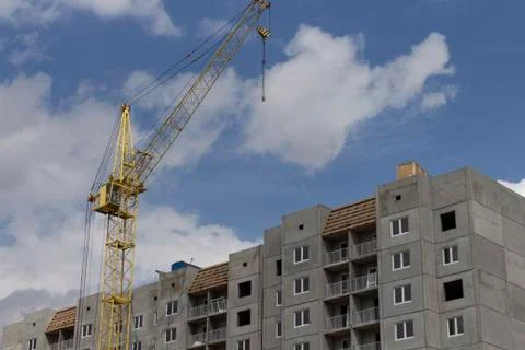 Construction site. Construction site with a crane. A concrete gray building Stock Photos