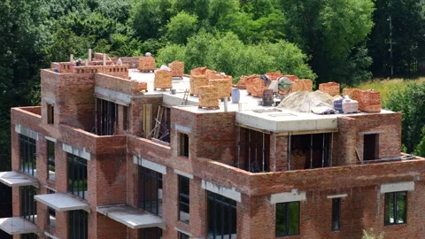 Construction site. Construction workers make a wall out of brick. Stock Footage 313338210