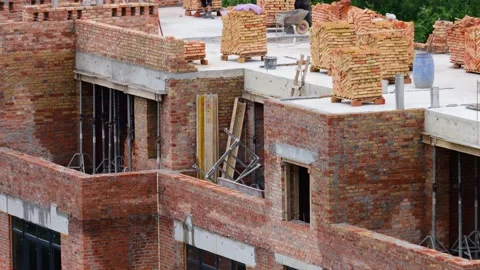 Construction site. Construction workers make a wall out of brick. Stock Footage 313338266