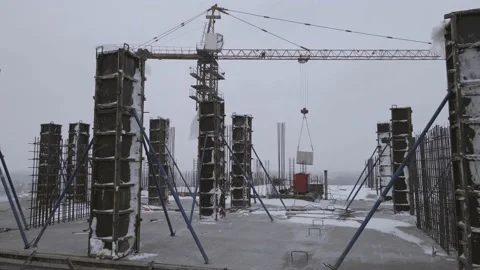 Construction site, crane and buildings in the city. gray sky, winter. Drone Stock Footage 237993563